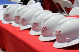 Hard hats with a TexAmericas Center logo illustrates the construction strenghts of the organization.